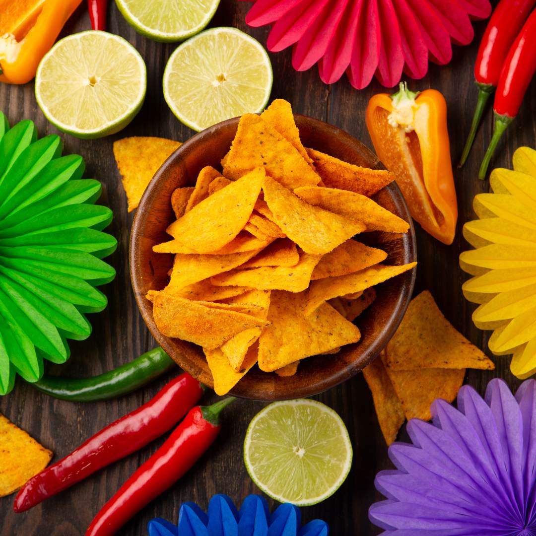 Colorful paper stars with lime wedges, chili peppers and some tortilla chips in the center