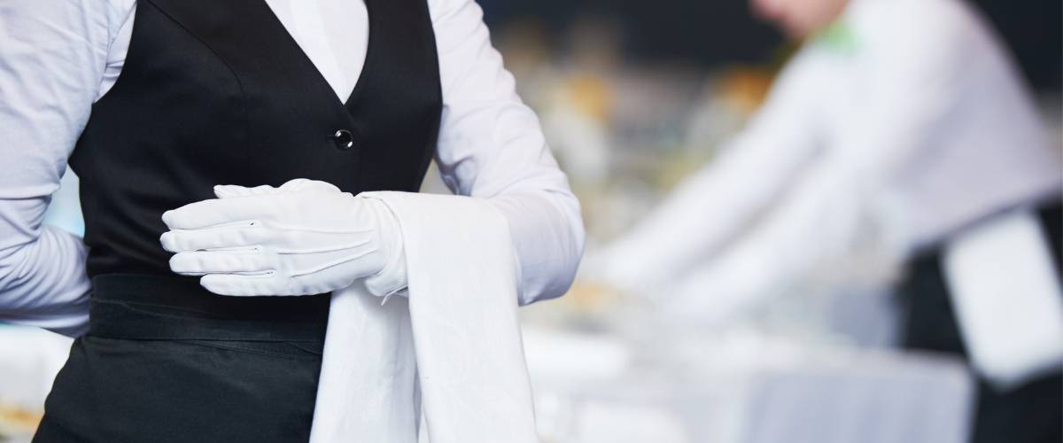 White gloved catering server with towel