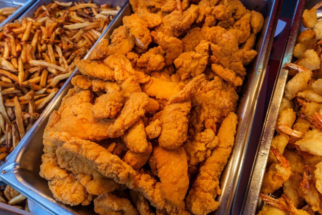 Catering pans full of kid favorites like chieck tenders and fries