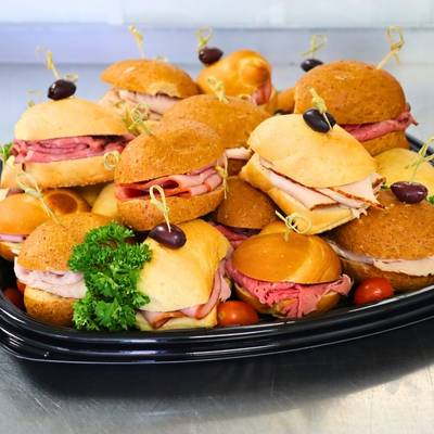 Tray of assorted deli sandwiches on a black tray