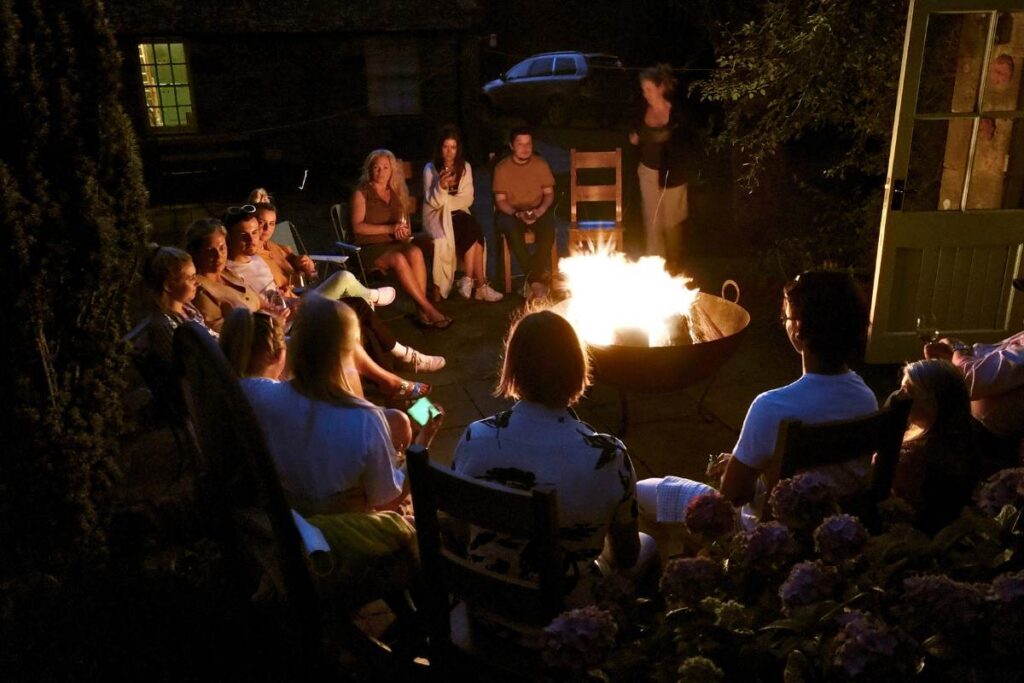 Story time around the fire pit at a summer party